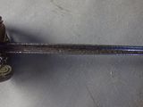a metal spoon with a handle that is on a table