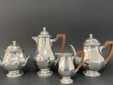 four pieces of silver tea and coffee set with wooden handles
