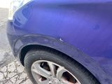 a close up of a car ' s tire on the street