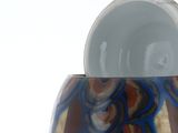 a glass vase that has a blue and brown design on it