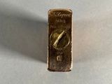 a close up of a small gold bar on a white surface
