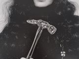 black and white photograph of a woman with a hammer in her hand