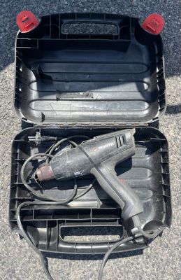 a tool in a case that is sitting on the ground