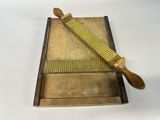 a wooden box with a knife on it and a wooden box with a knife on top of it