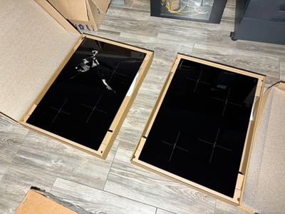 two stoves that are sitting in a box on the floor