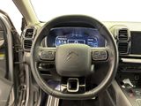 the interior of a car with a steering wheel and dashboard controls