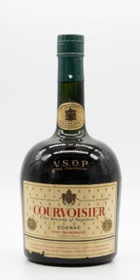 an old bottle of courvoisir is sitting on a white surface