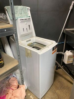 a washer and dryer in a room with shelves