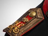 a close up of a military uniform with a red collar