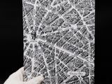 someone is holding a piece of paper with a map of paris on it