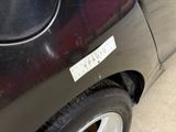 a black car with a sticker on the side of it