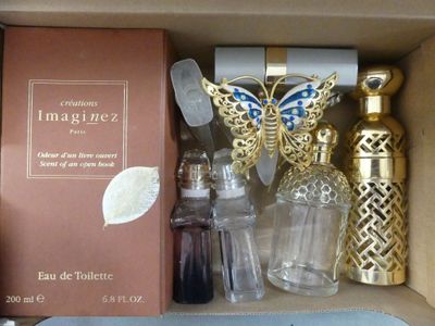 a box with perfume bottles and a book in it