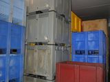 many crates stacked up in a room next to each other