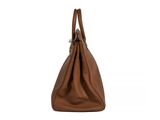 a brown leather bag with a handle on a white background