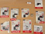 a lot of sandisk sd cards sitting on a table