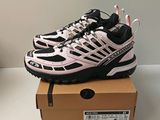 the shoe box is full of a pair of pink and black sneakers