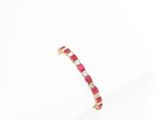 a close up of a pink and white diamond bracelet on a white surface