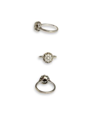three silver rings and a diamond ring on a white background