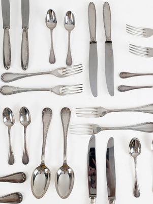 a lot of silver spoons and forks on the table