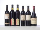 several bottles of wine are lined up on a table