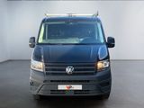 the front view of a blue van parked in a white room