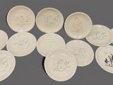 many plates with different designs on them on a table