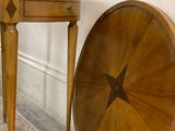 a wooden table with a star on it next to a wall