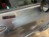 a silver car with a sticker on the side of it