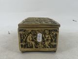 an antique brass box on a white background with a tag on the lid