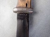 a knife with a wooden handle that has a clock on it