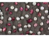 a lot of pearls on a cloth with a white background