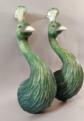 pair of green ceramic peacocks sitting on top of each other
