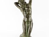 a bronze statue of a woman holding her head in her hands