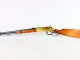 a rifle on a white surface with a white background