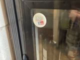 a close up of a glass door with a sticker on it