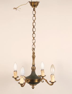 a close up of a chandelier with three lights hanging from it
