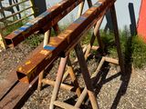 two wooden benches sitting next to each other on the side of a building