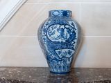 a blue and white vase sitting on a marble counter