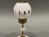 an image of a white and gold lamp with numbers on it