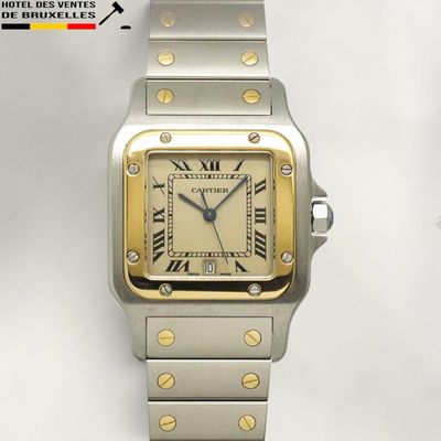 an image of a silver and gold watch with roman numerals
