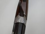 an old gun with a wooden handle on a white surface