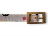 the belt is made of white and pink fabric with a gold buckle