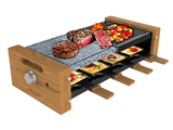 a grill with meat and vegetables on it on a table