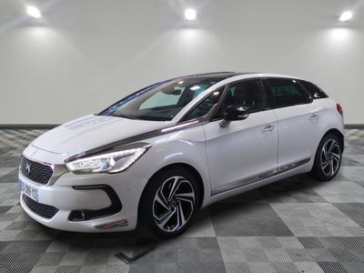 a white car is parked in a room with a checkered floor