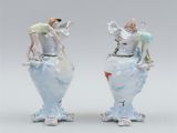 pair of porcelain figurines of a man and a woman on a vase