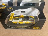 two boxed boxes with a yellow race car in them on a table