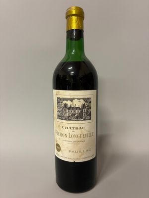 bottle of red wine with a label on it sitting on a table