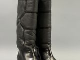 a pair of black leather boots on a white background