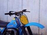 a blue motorcycle parked on the side of the road