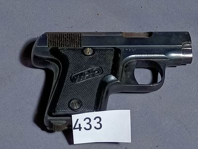 a gun that is on a table with a price tag